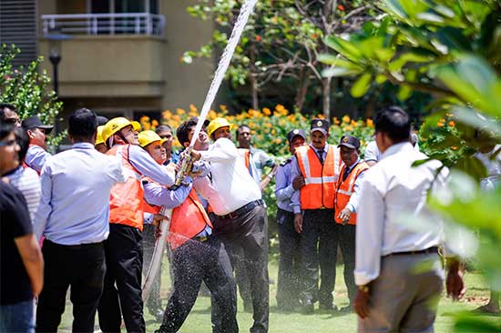 security guards holding a hose and spraying water